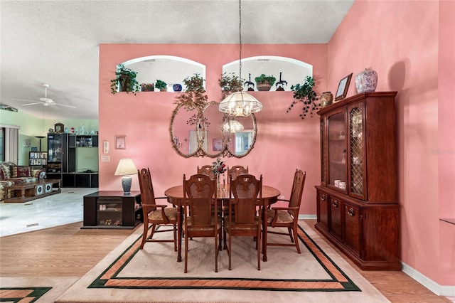 3603 Westerham Dr, Clermont, FL 34711 - dining space with a textured ceiling, light wood-type flooring, and ceiling fan with notable chandelier