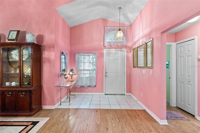 3603 Westerham Dr, Clermont, FL 34711 - foyer entrance featuring high vaulted ceiling, baseboards, and wood finished floors