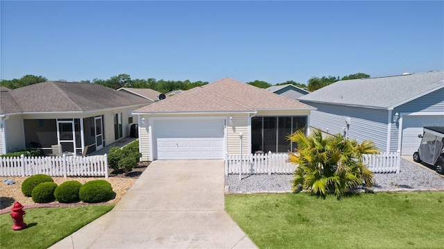 single story home featuring fence, a shingled roof, concrete driveway, a sunroom, and a garage