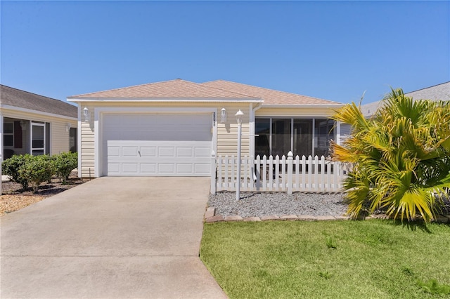 single story home featuring fence, concrete driveway, roof with shingles, a front yard, and a garage