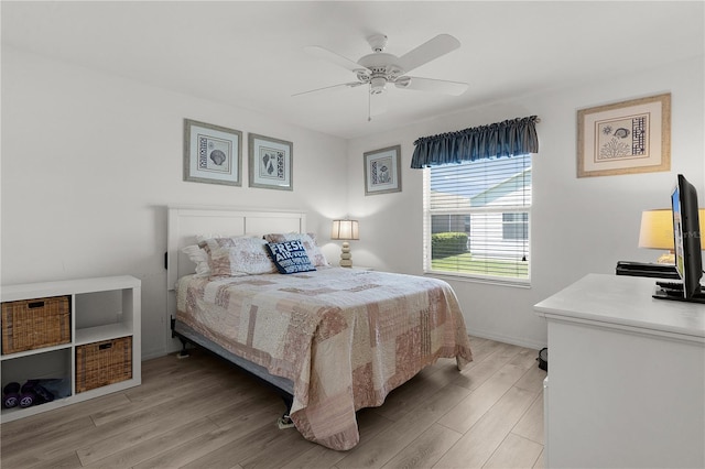 bedroom with light wood-type flooring, baseboards, and ceiling fan