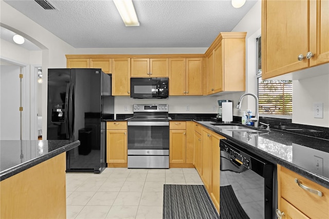 1358 E Schwartz Blvd, The Villages, FL 32159 - kitchen featuring a textured ceiling, visible vents, a sink, black appliances, and dark stone counters