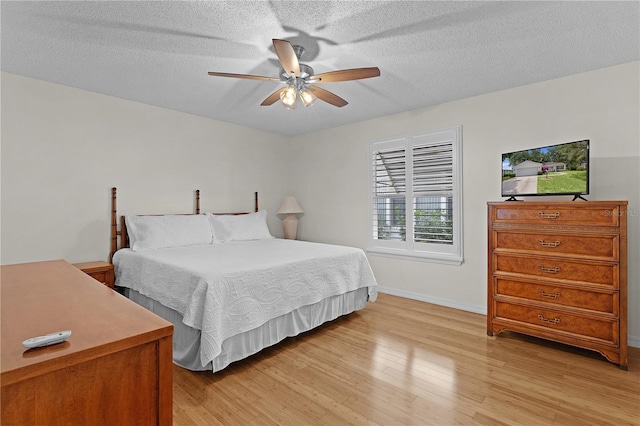 1358 E Schwartz Blvd, The Villages, FL 32159 - bedroom with light wood-style floors, a textured ceiling, baseboards, and ceiling fan