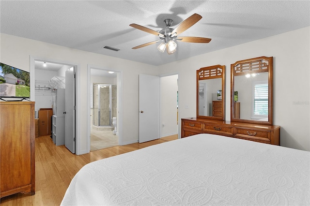 1358 E Schwartz Blvd, The Villages, FL 32159 - bedroom with ceiling fan, visible vents, a spacious closet, ensuite bath, and light wood-style flooring
