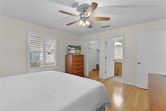 1358 E Schwartz Blvd, The Villages, FL 32159 - bedroom featuring visible vents, baseboards, a walk in closet, ceiling fan, and light wood finished floors