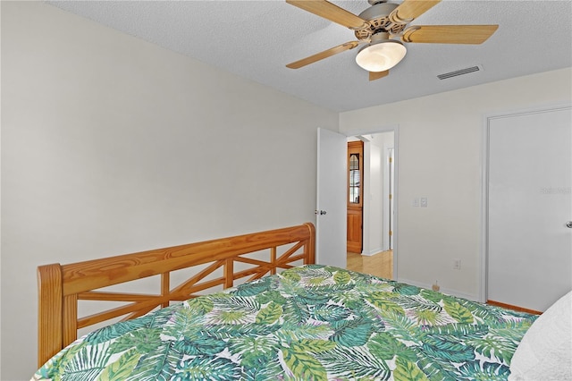 1358 E Schwartz Blvd, The Villages, FL 32159 - bedroom with light colored carpet, a textured ceiling, a ceiling fan, baseboards, and visible vents