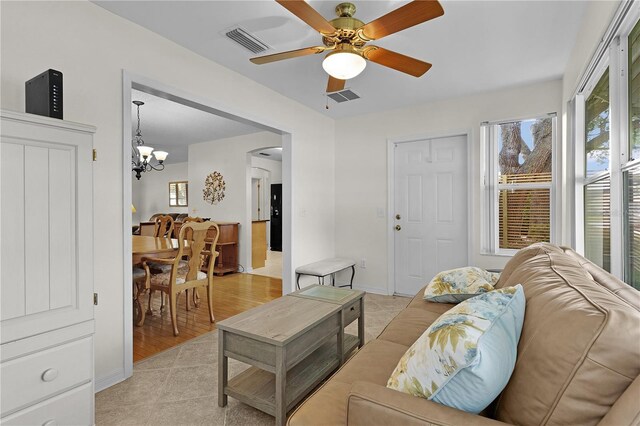 1358 E Schwartz Blvd, The Villages, FL 32159 - living area with arched walkways, baseboards, visible vents, and ceiling fan with notable chandelier