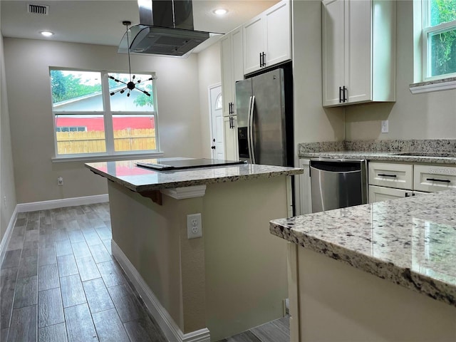 kitchen featuring visible vents, appliances with stainless steel finishes, island range hood, and plenty of natural light