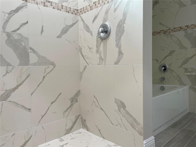full bath featuring a tile shower and a tub to relax in
