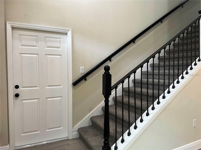 stairs featuring baseboards and wood finished floors