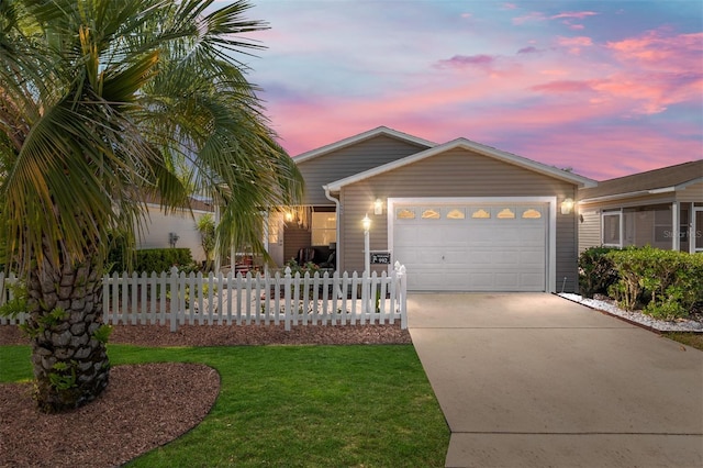 ranch-style home with fence, concrete driveway, a yard, and an attached garage