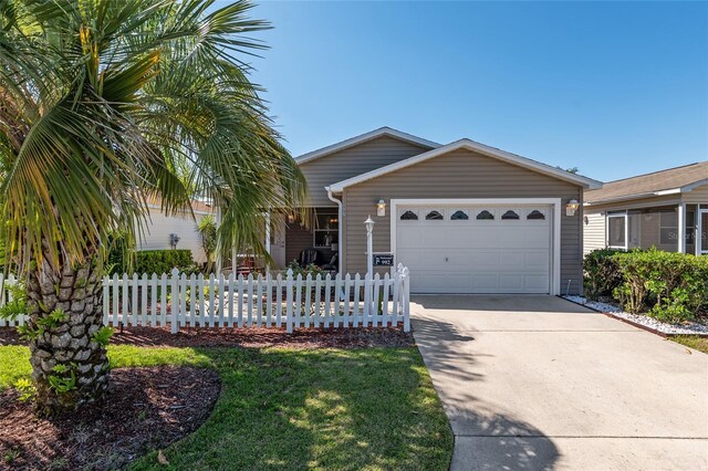 single story home featuring fence private yard, driveway, and an attached garage