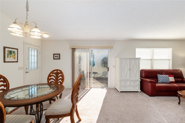 dining area featuring a chandelier and light colored carpet