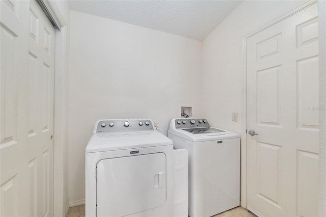 washroom with washing machine and clothes dryer and laundry area