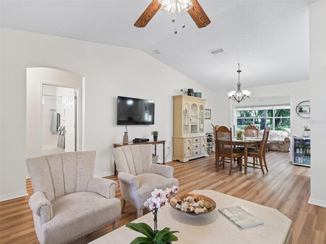 511 Chula Vista Ave, The Villages, FL 32159 - living room with ceiling fan with notable chandelier, light wood finished floors, lofted ceiling, wine cooler, and visible vents