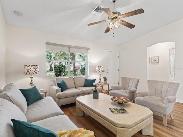 511 Chula Vista Ave, The Villages, FL 32159 - living room featuring arched walkways, wood finished floors, visible vents, and ceiling fan