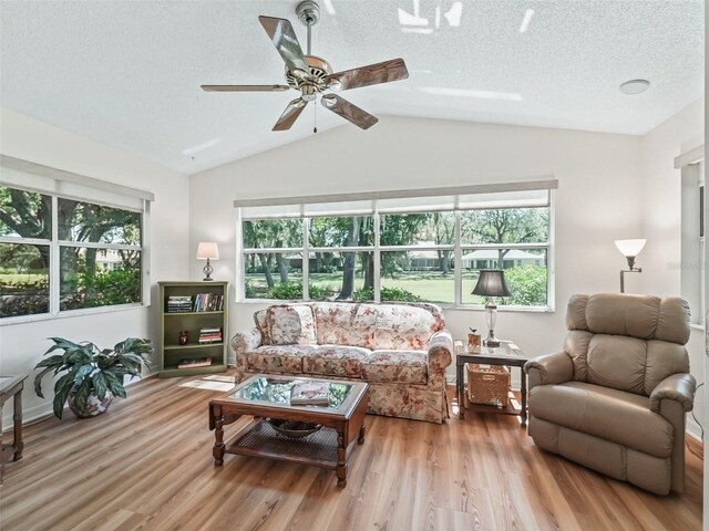 511 Chula Vista Ave, The Villages, FL 32159 - living room with lofted ceiling, plenty of natural light, wood finished floors, and ceiling fan