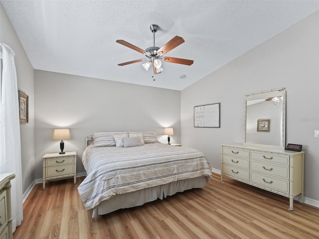 511 Chula Vista Ave, The Villages, FL 32159 - bedroom featuring vaulted ceiling, a textured ceiling, baseboards, and light wood-type flooring