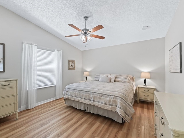 511 Chula Vista Ave, The Villages, FL 32159 - bedroom featuring a textured ceiling, light wood-type flooring, vaulted ceiling, baseboards, and a ceiling fan