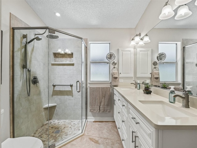 511 Chula Vista Ave, The Villages, FL 32159 - bathroom with double vanity, a sink, a textured ceiling, and a stall shower