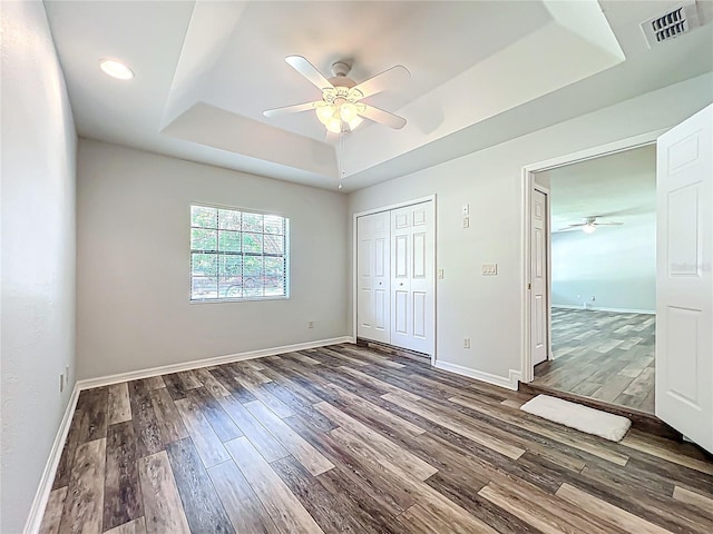 203 SE 30th Ave, Ocala, FL 34471 - unfurnished bedroom with a tray ceiling, wood finished floors, baseboards, a closet, and recessed lighting