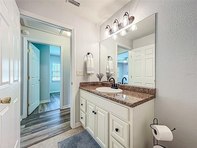 203 SE 30th Ave, Ocala, FL 34471 - bathroom with vanity, a textured wall, tile patterned flooring, ceiling fan, and baseboards