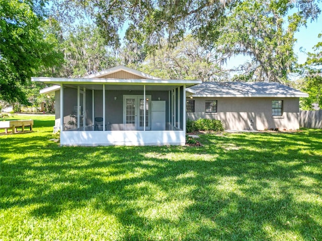 203 SE 30th Ave, Ocala, FL 34471 - back of house with a sunroom, a yard, and stucco siding
