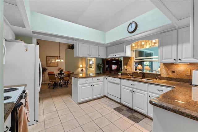 6608 Borg, Leesburg, FL 34748 - kitchen featuring light tile patterned floors, white appliances, a peninsula, a sink, and a notable chandelier