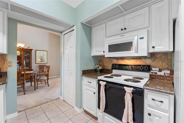6608 Borg, Leesburg, FL 34748 - kitchen with white microwave, white cabinetry, electric range, decorative backsplash, and light colored carpet