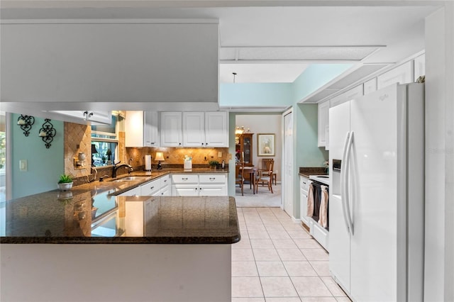 6608 Borg, Leesburg, FL 34748 - kitchen featuring white fridge with ice dispenser, a peninsula, white cabinetry, a sink, and range with electric stovetop