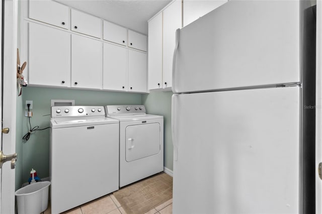 6608 Borg, Leesburg, FL 34748 - clothes washing area featuring washer and dryer, light tile patterned flooring, and cabinet space