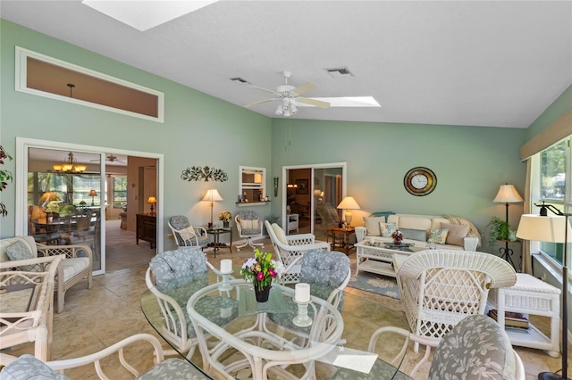 6608 Borg, Leesburg, FL 34748 - living area featuring plenty of natural light, vaulted ceiling with skylight, visible vents, and ceiling fan with notable chandelier