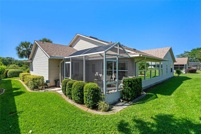 6608 Borg, Leesburg, FL 34748 - rear view of house featuring a shingled roof, a lanai, and a lawn