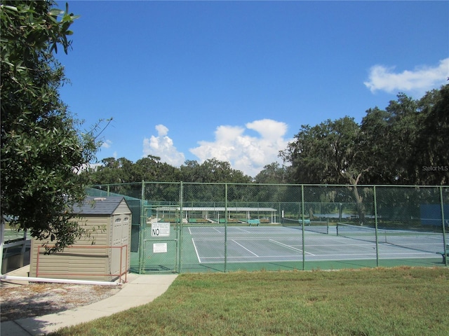 6608 Borg, Leesburg, FL 34748 - view of tennis court featuring fence and a lawn