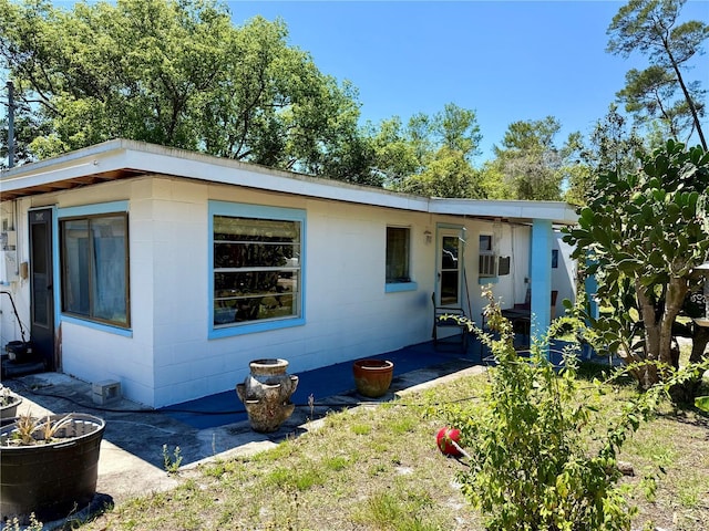 view of front of property featuring concrete block siding