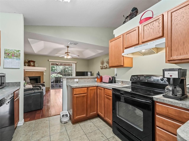kitchen featuring a peninsula, open floor plan, lofted ceiling, under cabinet range hood, and black appliances