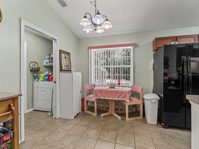 dining area featuring a chandelier, visible vents, light tile patterned floors, and washer / clothes dryer
