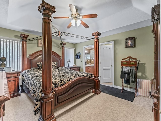 carpeted bedroom featuring connected bathroom, ceiling fan, and baseboards