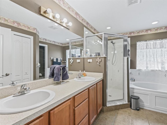 bathroom with a shower stall, a bath, a sink, and visible vents