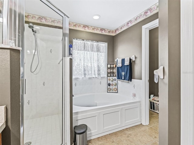 full bathroom featuring a bath, tile patterned floors, and a stall shower