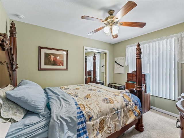 bedroom with carpet, a closet, ceiling fan, and multiple windows