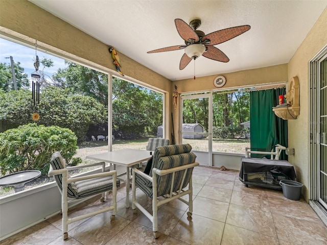 sunroom with outdoor dining space and ceiling fan