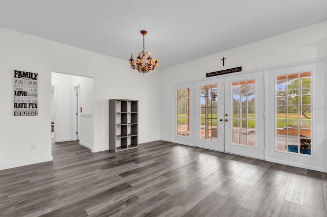 10901 Island Grove Rd, Clermont, FL 34711 - unfurnished dining area with a chandelier, dark wood finished floors, plenty of natural light, and french doors