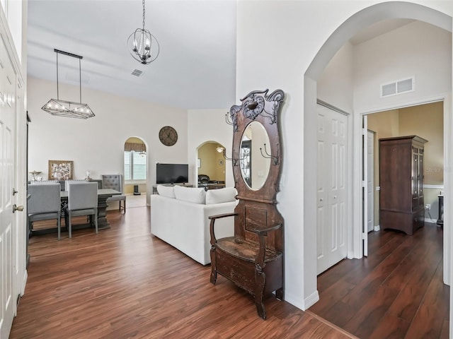 17787 SE 114th Ave, Summerfield, FL 34491 - interior space featuring a towering ceiling, visible vents, arched walkways, and dark wood-style flooring