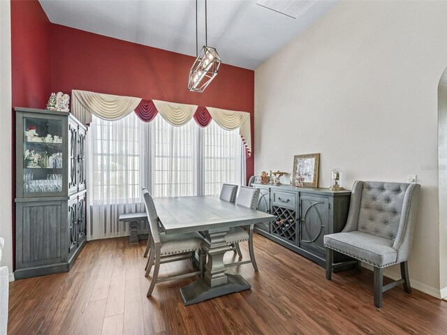 17787 SE 114th Ave, Summerfield, FL 34491 - dining space with baseboards, wood finished floors, arched walkways, and a healthy amount of sunlight