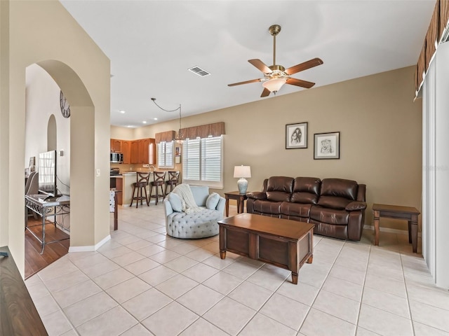 17787 SE 114th Ave, Summerfield, FL 34491 - living room with recessed lighting, visible vents, light tile patterned flooring, arched walkways, and ceiling fan