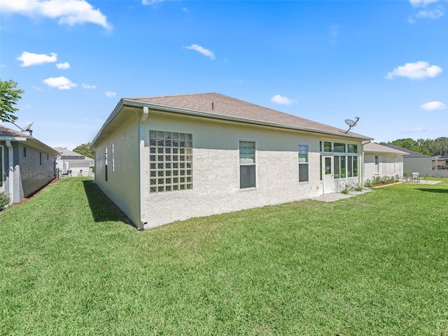 17787 SE 114th Ave, Summerfield, FL 34491 - back of property with a lawn and stucco siding