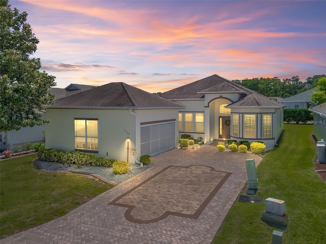 17787 SE 114th Ave, Summerfield, FL 34491 - single story home featuring a garage, a front lawn, decorative driveway, and stucco siding