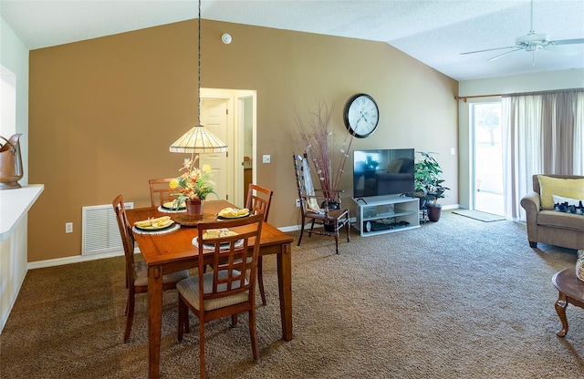 carpeted dining space with visible vents, baseboards, vaulted ceiling, and a ceiling fan