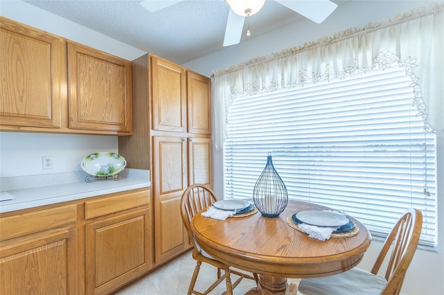 dining room featuring light tile patterned flooring, a healthy amount of sunlight, and ceiling fan